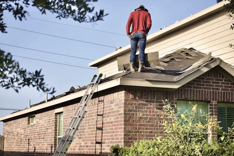 Professional roofer working on a residential roof in East Bridgeport